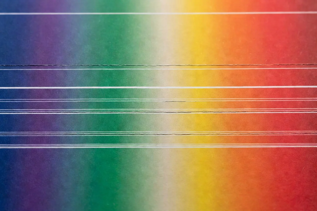 Macro photograph of a printed color gradient chart showing visible banding stripes